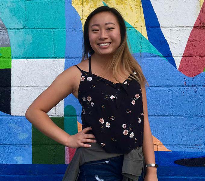 Portrait of Karen Yang in front of a colorful mural